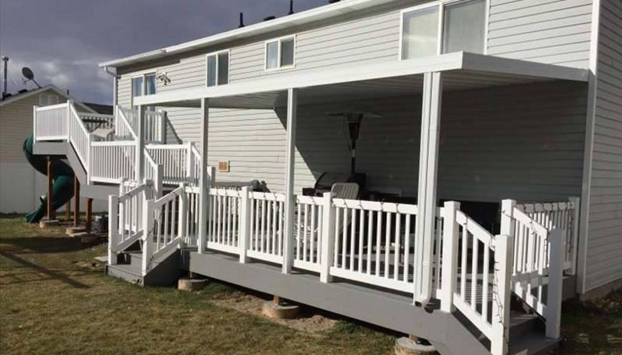 Multi level composite pebble grey Trex decking with matching fascia 8x8 upper level and 20x10 lower deck.