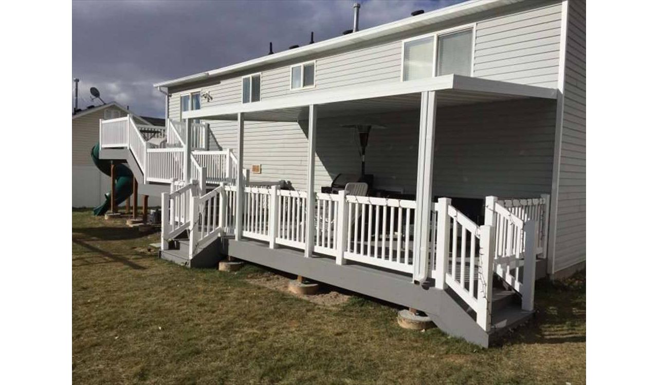Multi level composite pebble grey Trex decking with matching fascia 8x8 upper level and 20x10 lower deck.