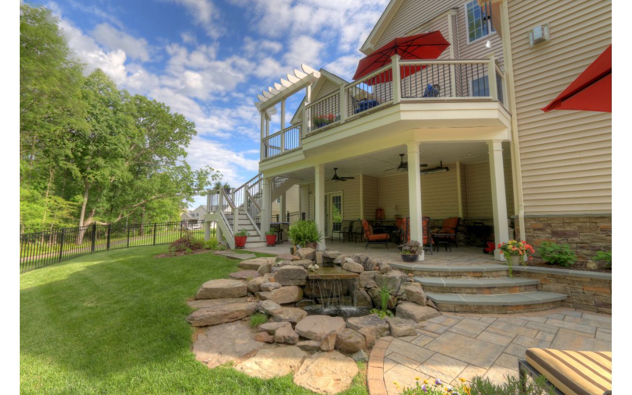 Trex Transcends Deck with Rain Escapes, Water Feature, & Custom Patio