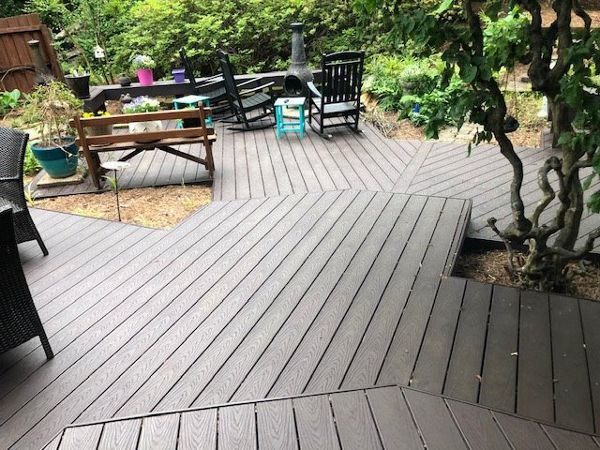 The large lower deck winds its way around trees, shrubs & landscaping in a gorgeous way