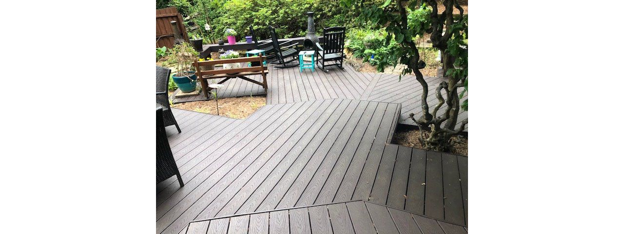 The large lower deck winds its way around trees, shrubs & landscaping in a gorgeous way