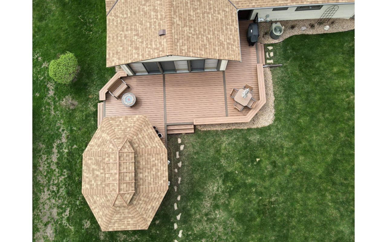 Overhead view of Trex deck with 2 tone picture frame and center ribbons. Built in benches and Trex low voltage lighting as well