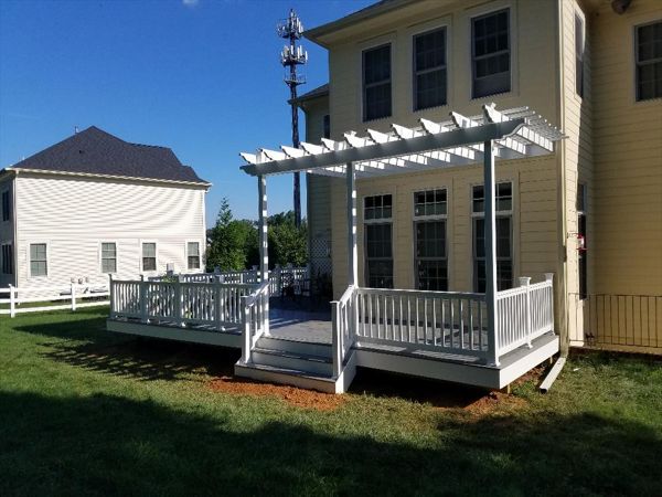 Trex Select Pebbly Grey decking with white pvc railings. This deck also features a PVC Sun Trellis
