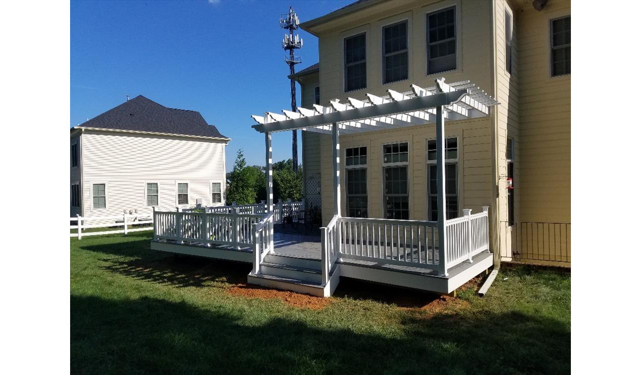 Trex Select Pebbly Grey decking with white pvc railings. This deck also features a PVC Sun Trellis