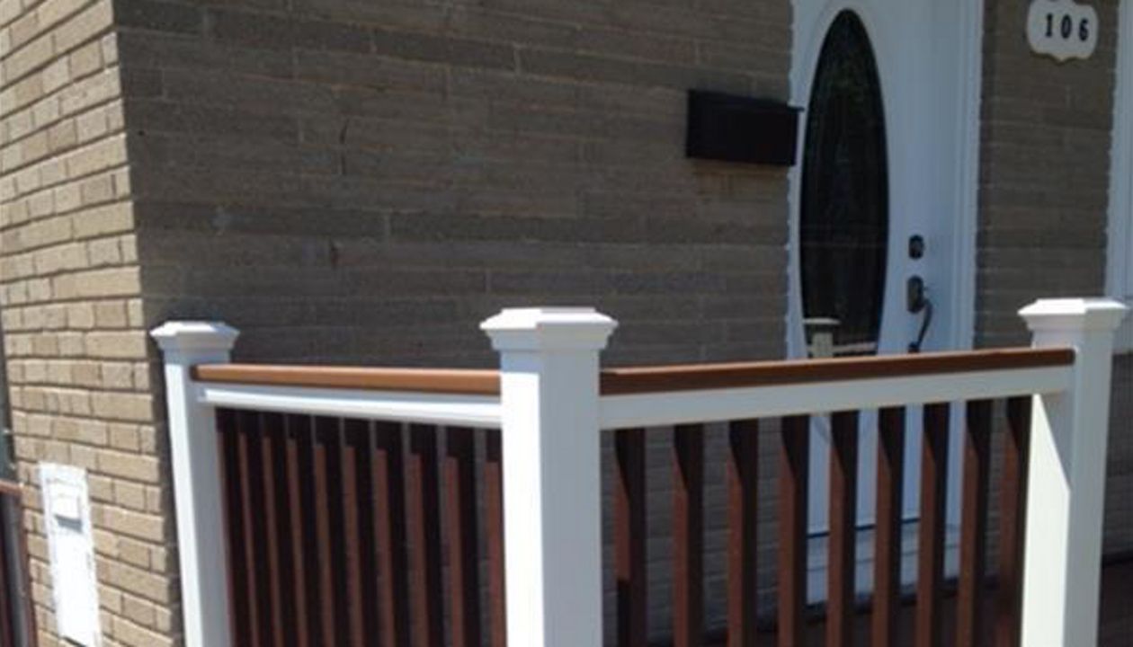 Trex Select Saddle custom made COMPOSITE porch with Trex Select Madeira railing and classic white posts. The Porch built in Toronto, Mississauga, Scarborough, Etobicoke, North York, Markham, RTrex