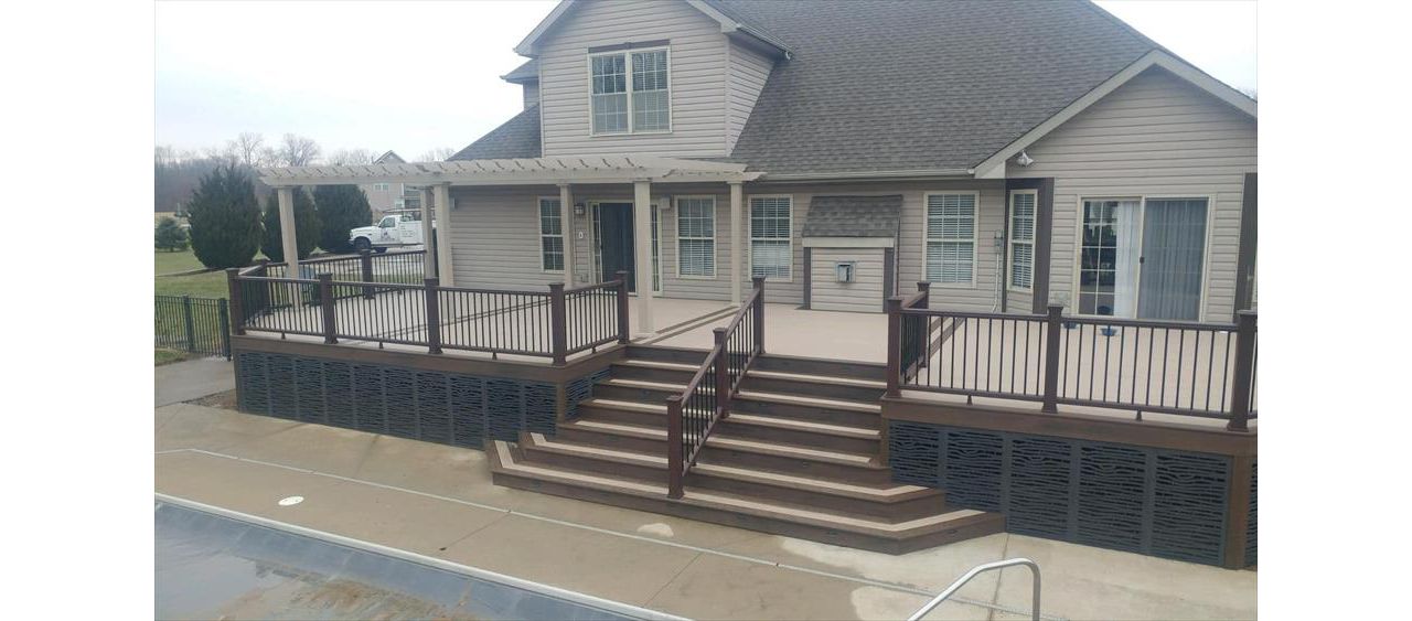 custom deck with flared staircase, triple border, 3-tread wide bordered staircase, lighting, vinyl pergola, and decorative skirting