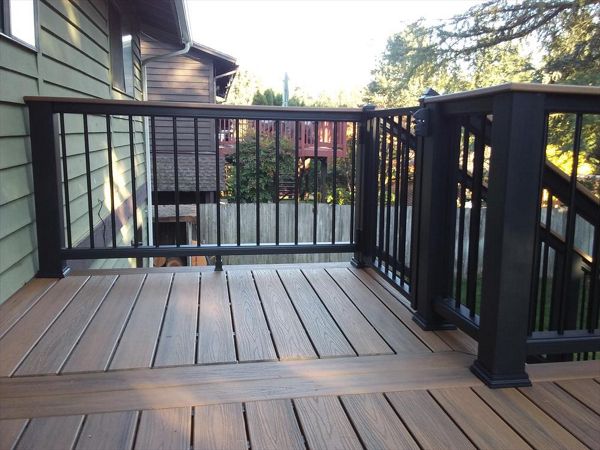 Trex Transcend Tropical Havana Gold decking and cocktail rail with Trex Transcend black composite rail with aluminum pickets.