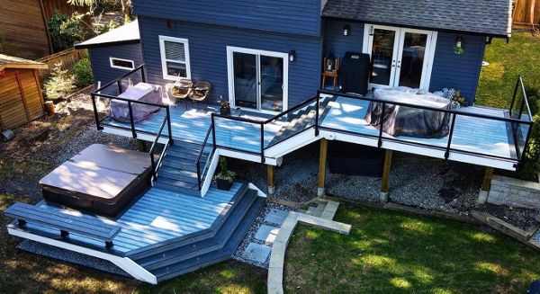 Foggy Wharf field and risers with Clamshell bordering, lighting package, and aluminum railing. This three-tiered deck suggests different ways to relax at every level.