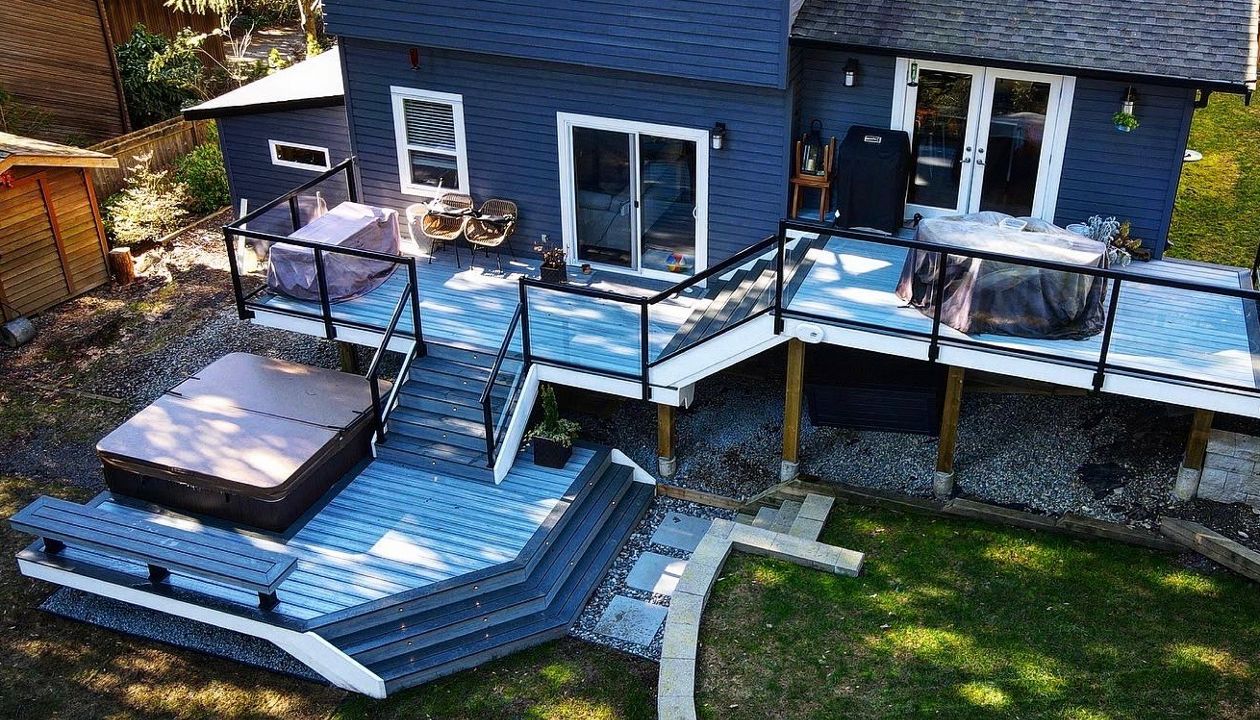 Foggy Wharf field and risers with Clamshell bordering, lighting package, and aluminum railing. This three-tiered deck suggests different ways to relax at every level.