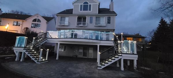 TREX Island mist decking, Custom curved TREX CLAMSHELL radius￼... Illuminated Glass Rail￼..... Trex Rain Escapes... bead board soffit... dental molding... Recessed crown molding underneath with backlit LED lighting￼