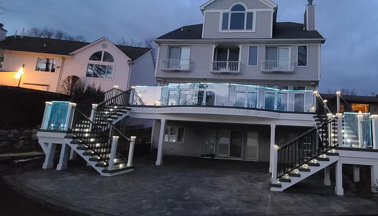 TREX Island mist decking, Custom curved TREX CLAMSHELL radius￼... Illuminated Glass Rail￼..... Trex Rain Escapes... bead board soffit... dental molding... Recessed crown molding underneath with backlit LED lighting￼