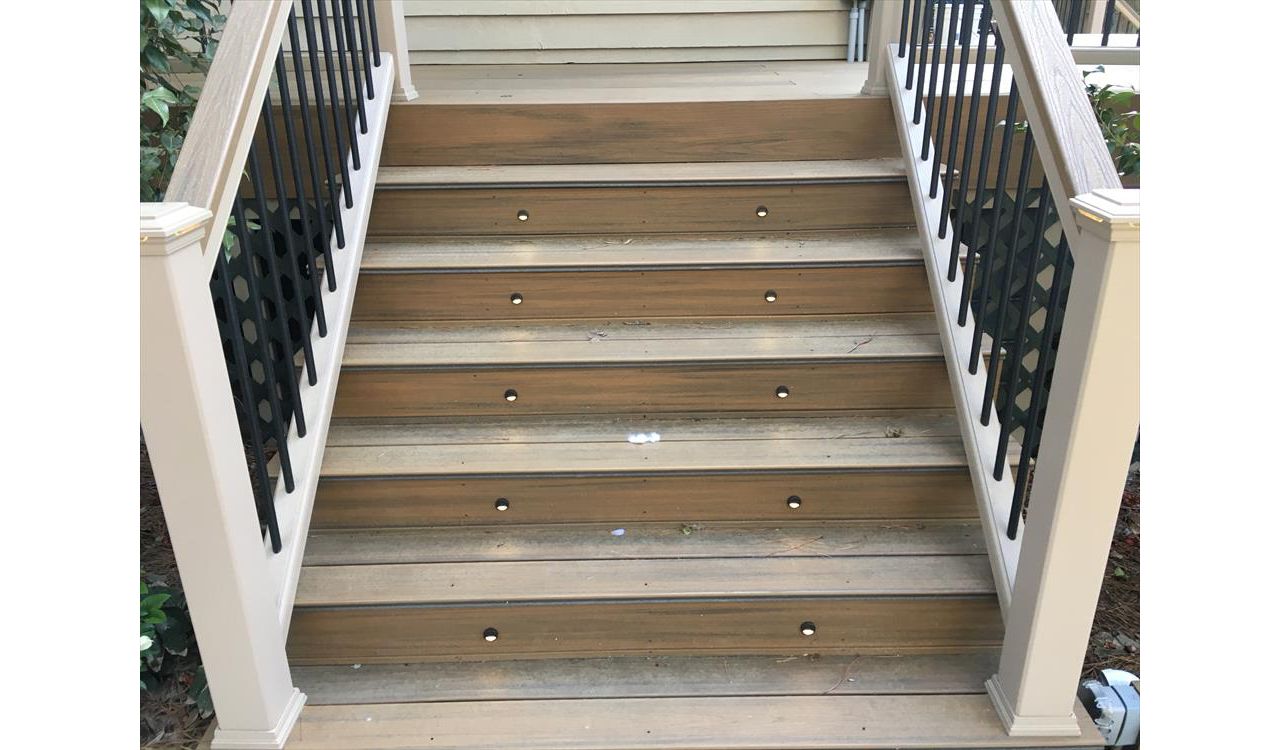 Trex Transcend stairs with black riser lights provide a safe way to come up on this deck and have a great time!