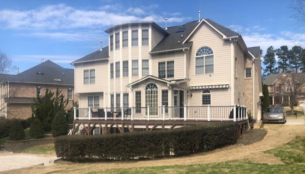 Majestic new Trex Select Saddle deck with Transcend Classic White Railing, LED lighting & RainEscape!