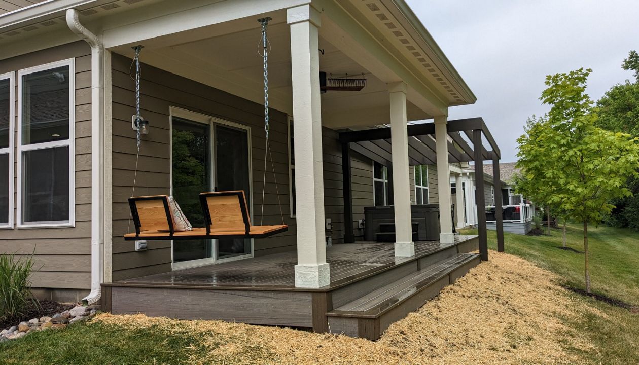 Trex Enhance Naturals in Rocky Harbor and Coastal Bluff with custom pergola over new concrete hot tub slab.
