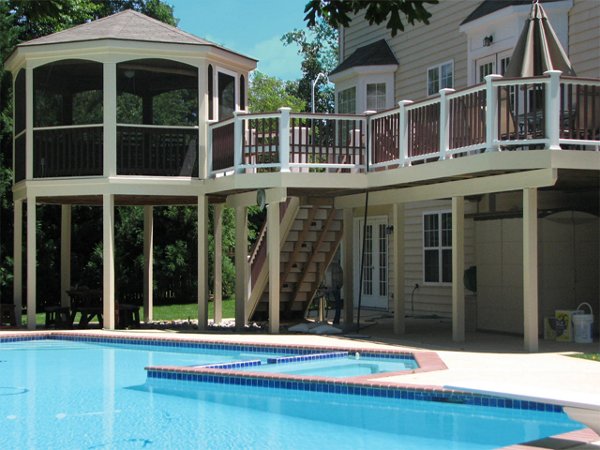 Screened in porch with decking in Trex Foggy Wharf with two Adirondack chairs looking out on the yard