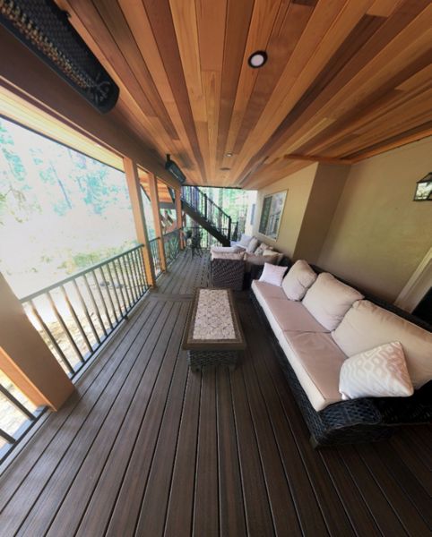 Trex Spiced Rum deck with Trex Rain Escapes and a cedar soffit with canned lighting.