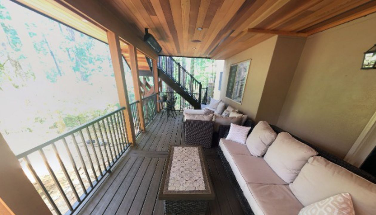 Trex Spiced Rum deck with Trex Rain Escapes and a cedar soffit with canned lighting.