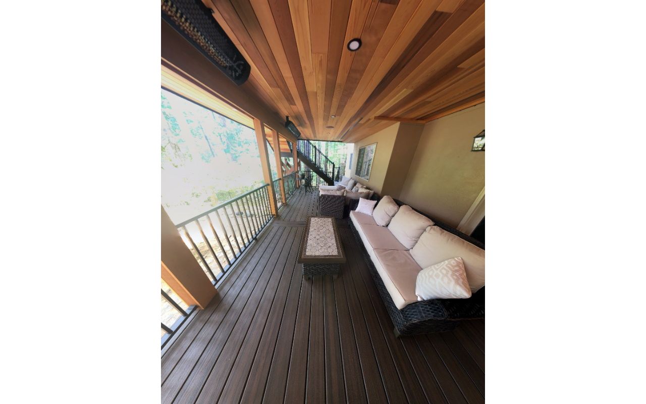 Trex Spiced Rum deck with Trex Rain Escapes and a cedar soffit with canned lighting.