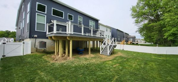 Pebble Grey Deck with Cocktail rail, rise lights in wrap around steps and customary grill bumpout!