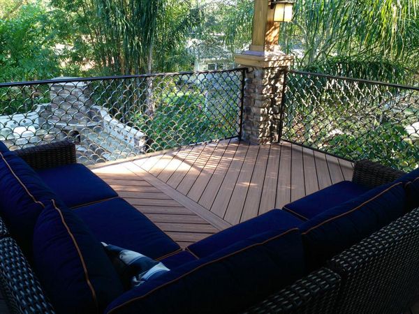Trex Transcend decking in Tiki Torch and custom aluminum railing looks like the perfect combination for this homeowners "cigar deck"