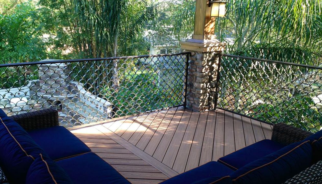 Trex Transcend decking in Tiki Torch and custom aluminum railing looks like the perfect combination for this homeowners "cigar deck"