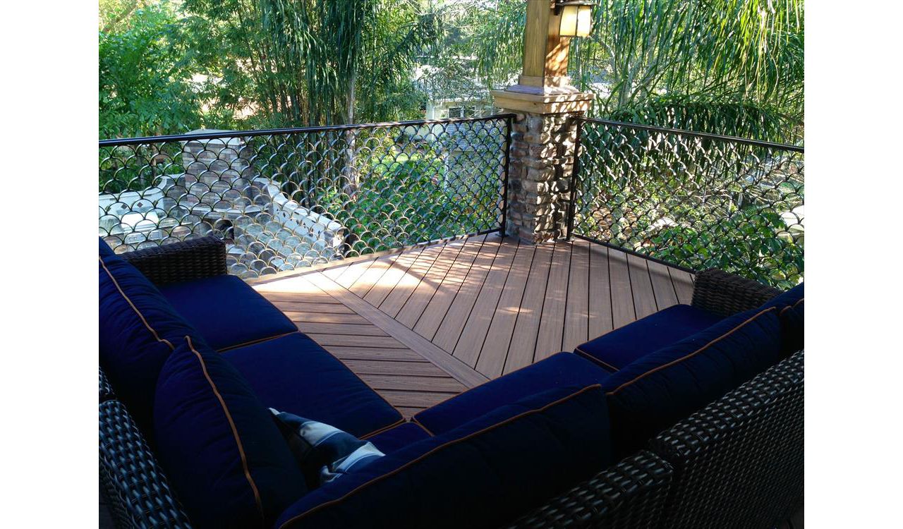 Trex Transcend decking in Tiki Torch and custom aluminum railing looks like the perfect combination for this homeowners "cigar deck"