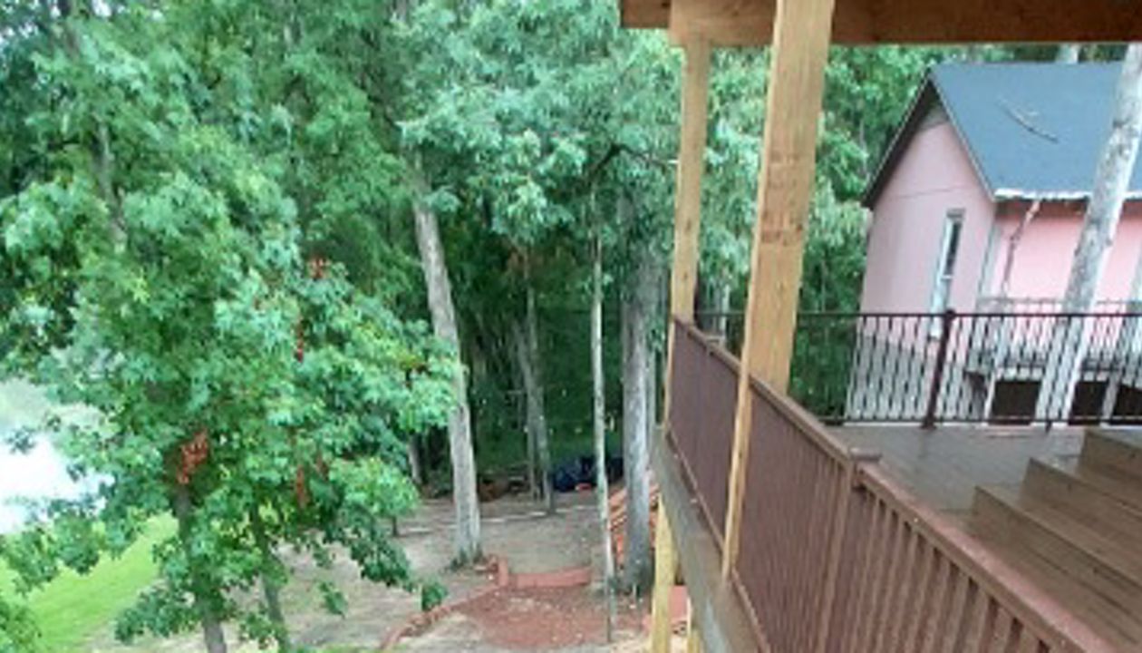 Multi-Tiered Covered Deck Stairs in Spiced Rum with Bronze Signature Railings and Trex Riser Lighting