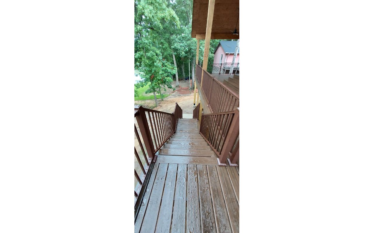 Multi-Tiered Covered Deck Stairs in Spiced Rum with Bronze Signature Railings and Trex Riser Lighting