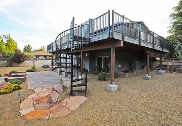 Spiral stairs and landscaping with this Trex Deck