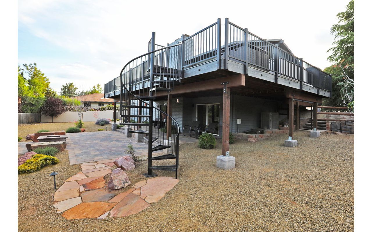 Spiral stairs and landscaping with this Trex Deck