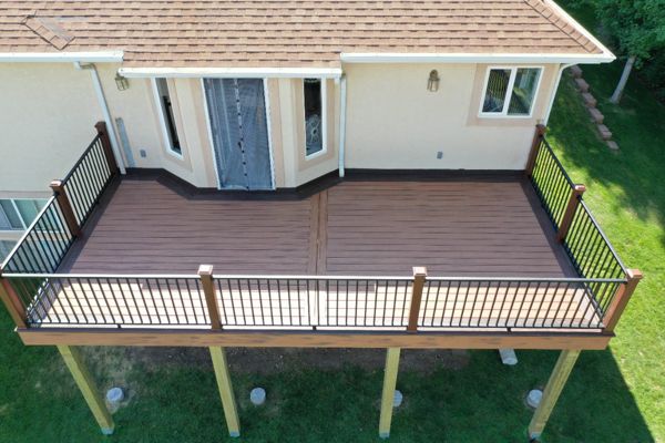 Transcend decking Tiki Torch and Lava Rock border with Signature Railing