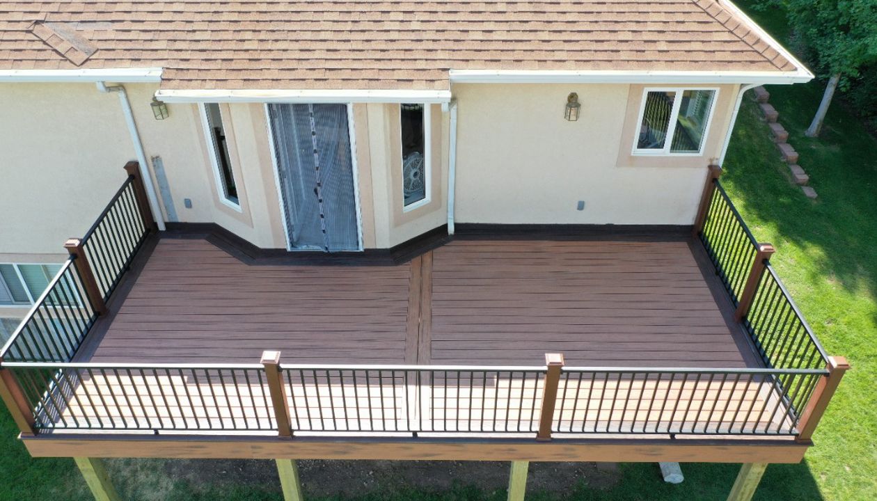 Transcend decking Tiki Torch and Lava Rock border with Signature Railing