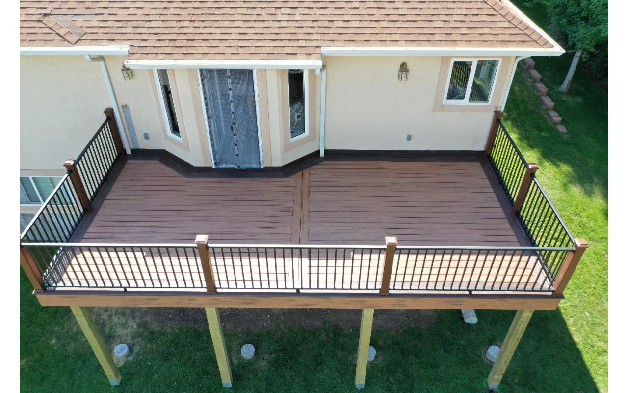 Transcend decking Tiki Torch and Lava Rock border with Signature Railing