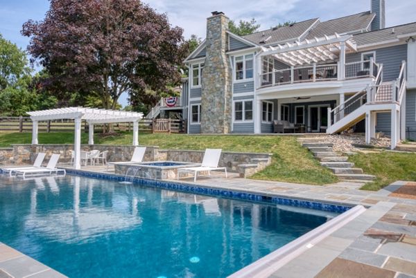 Trex Transcends Deck with Rain Escapes, Trex Pergolas, Custom Pool, & Hardscapes