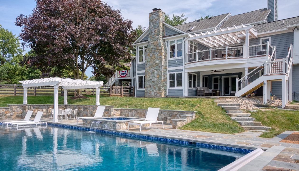 Trex Transcends Deck with Rain Escapes, Trex Pergolas, Custom Pool, & Hardscapes