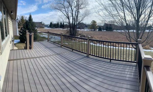 Trex enhance decking with rocky harbor as main deck, coastal bluff as picture frame & middle divider. Enhance rocky harbor as fascia. Transcend railing. Rope swing post sleeves, vintage lantern top/bottom rail & black square aluminum balusters