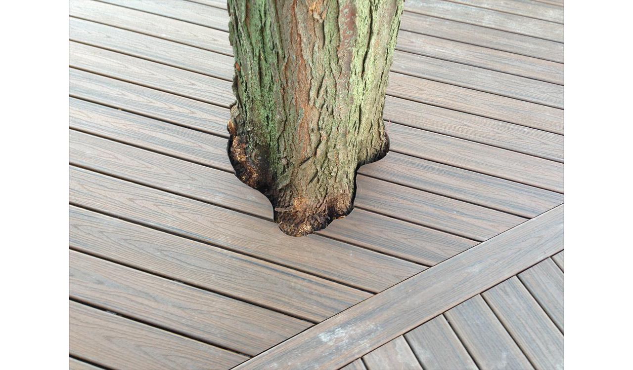 Check out this Trex deck Images Landscaping Images and Construction built in Northville, MI out of Trex Transcend Spiced Rum decking, with special cuts made as to keep the beautiful old tree as part of the outdoor living space.