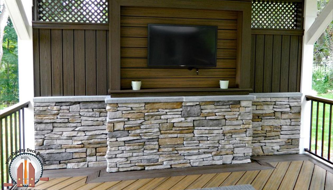 Trex Transcend decking in Havana Gold and Spiced Rum created a custom TV Wall under a covered pavilion in Upper Saddle River, NJ.