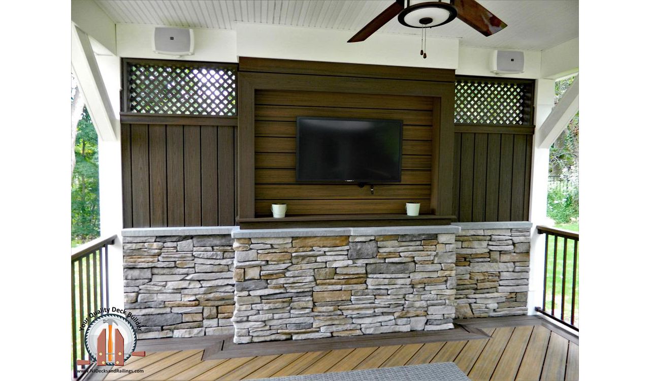Trex Transcend decking in Havana Gold and Spiced Rum created a custom TV Wall under a covered pavilion in Upper Saddle River, NJ.
