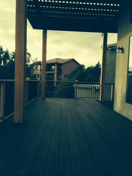 Prescott AZ. Lava Rock with groove, hidden clips. Trex joist tape.  Metal railing and redwood top cap.