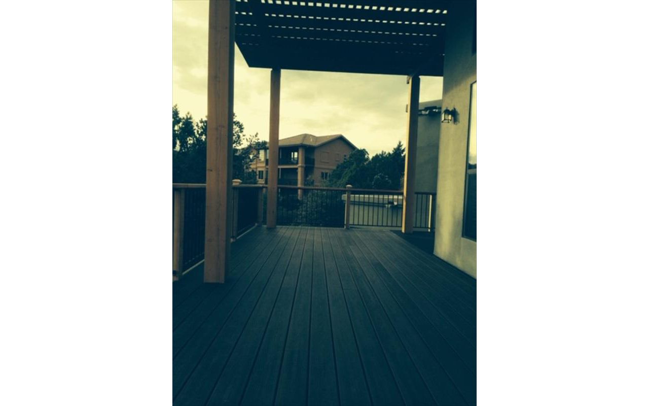 Prescott AZ. Lava Rock with groove, hidden clips. Trex joist tape.  Metal railing and redwood top cap.