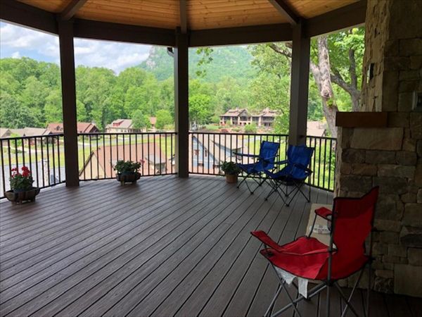 Trex Transcend Lava Rock decking &amp; Trex Signature Bronze railing look fantastic on this rustic style custom home &amp; covered porch