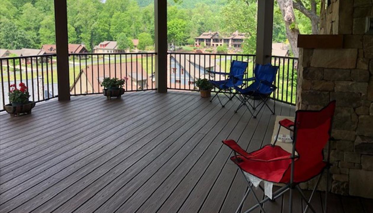 Trex Transcend Lava Rock decking &amp; Trex Signature Bronze railing look fantastic on this rustic style custom home &amp; covered porch