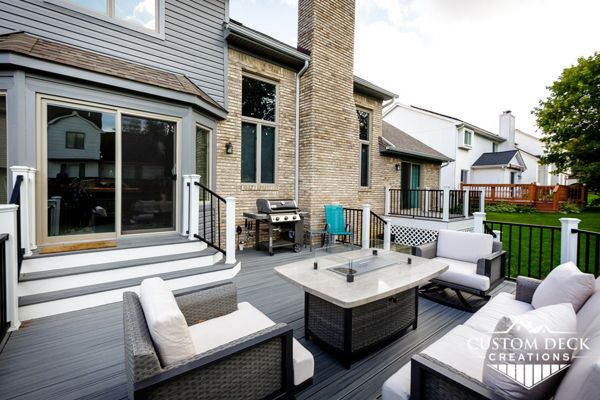 Trex Transcend Island Mist decking with white Trex fascia. Railing is black Trex Signature aluminum railing and white Trex Transcend composite composite railing posts