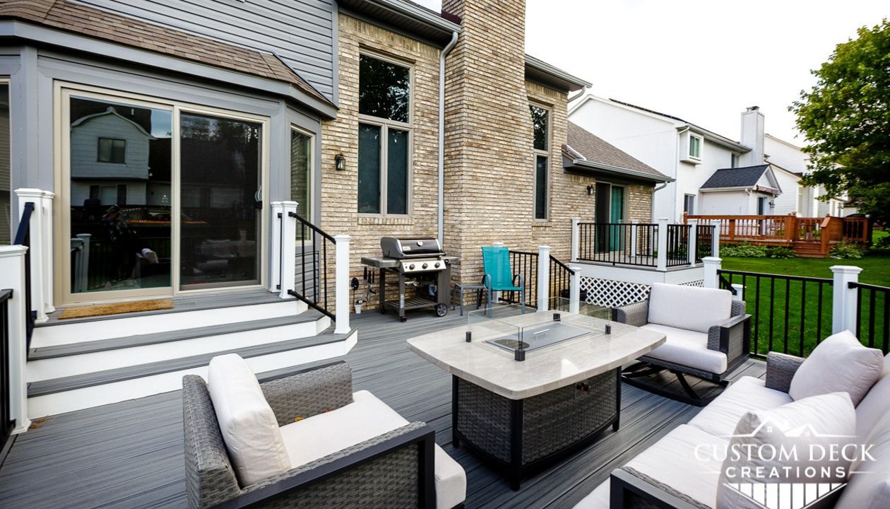 Trex Transcend Island Mist decking with white Trex fascia. Railing is black Trex Signature aluminum railing and white Trex Transcend composite composite railing posts