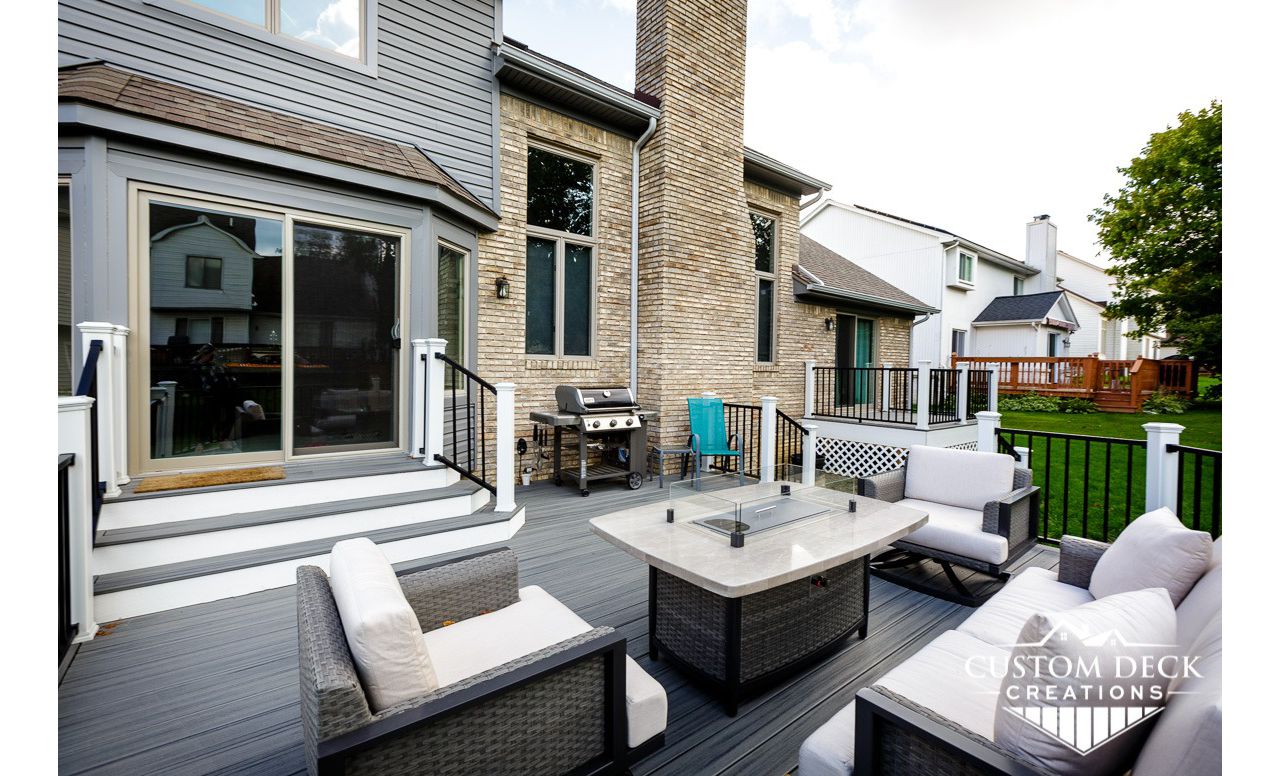 Trex Transcend Island Mist decking with white Trex fascia. Railing is black Trex Signature aluminum railing and white Trex Transcend composite composite railing posts