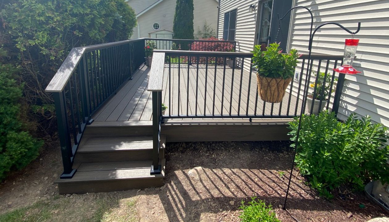 Enhanced Naturals - Coastal Bluff decking, picture frame and fascia with a Transcends - Spiced Rum drink rail