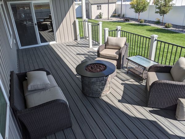 Island Mist Decking and Skirting, Black Iron Metal Rail and white Trex Posts.