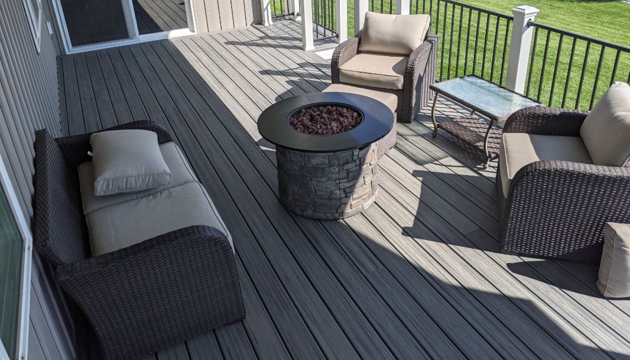 Island Mist Decking and Skirting, Black Iron Metal Rail and white Trex Posts.