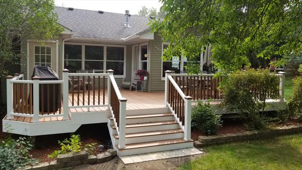 Trex Transcend Tropics Tiki Torch deck boards with Transcend crown railing (classic white rails with tree house balusters), Classic white fascia serving the Twin Cites, Hastings, Woodbury, Egan, Edina, Minneapolis, Lake of the Isles